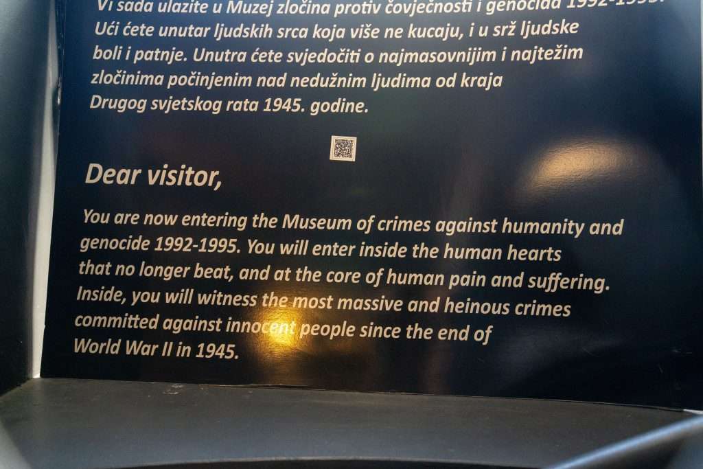 At the Museum entrance, a sign delves into the harrowing crimes against humanity and genocide from 1992-1995, spotlighting profound human suffering post-World War II. Include this as a poignant stop in your one-day Sarajevo itinerary to truly understand the city's somber history.