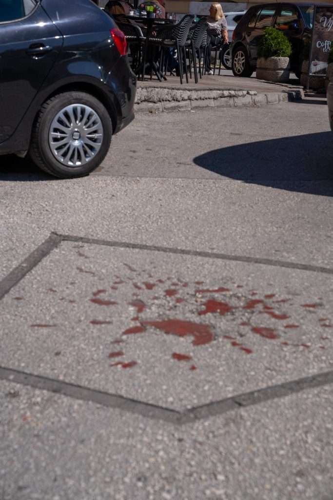 Image of fake red blood splats on the ground symbolising a Sarajevo Rose in Sarajevo