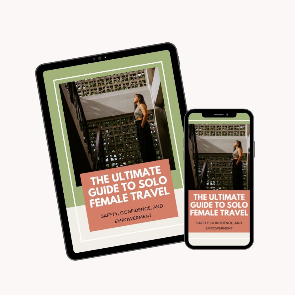 A tablet and a smartphone display the cover of an e-book titled "The Ultimate Guide to Solo Female Travel: Safety, Confidence, and Empowerment," featuring a woman standing on a staircase.