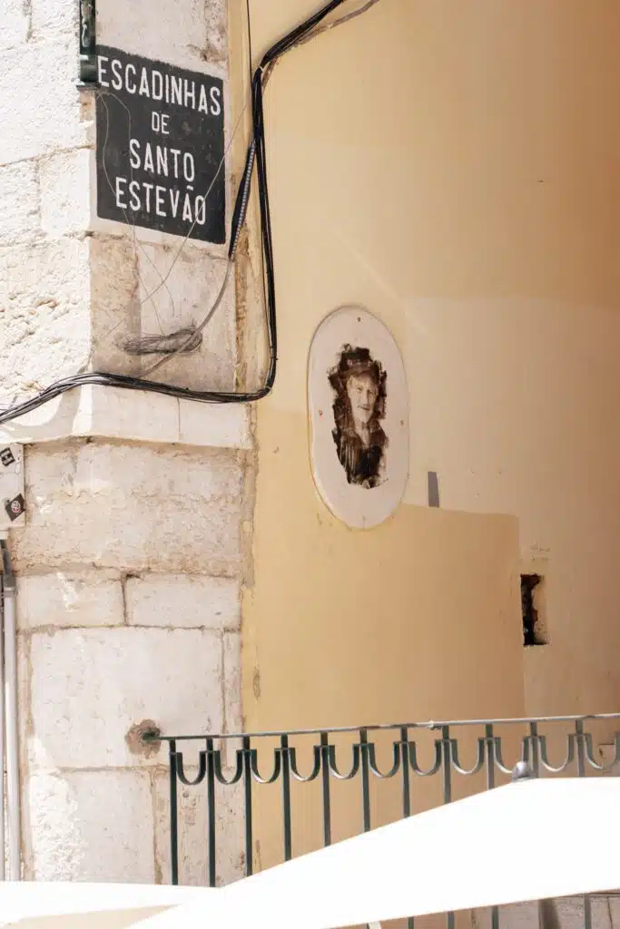 A sign on a building hints at hidden gems perfect for discovering during 3 days in Lisbon.