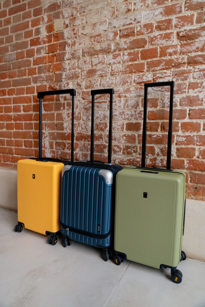 Level8 carry-on suitcases in yellow, blue and olive green.